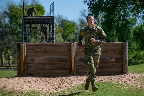 A trainee from Alpha Battery, 1st Battalion, 79th Field Artillery Regiment, 434th Field Artillery Brigade, Fort Sill, Okla., slides down a rope during an obstacle course while training at basic .... 
