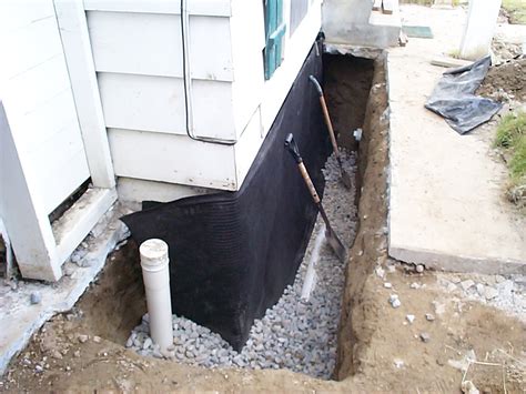 Foundation drain. 1. Water-Managed Site and Foundation. 1.8 Drain tile installed at basement and crawlspace walls, with the top of the drain tile pipe below the bottom of the concrete slab or crawlspace floor. Drain tile surrounded with ≥ 6 in. of ½ to ¾ in. washed or clean gravel and with gravel layer fully wrapped with fabric cloth. 