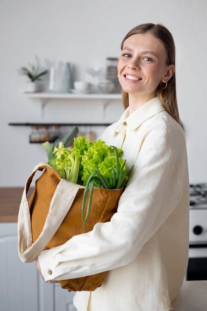 Free Photo Medium shot smiley girl posing with bag