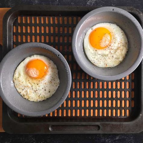 Fried egg in air fryer. Break one egg into each pan and sprinkle them with salt and pepper. Air fry the eggs for 4 minutes at 370 degrees F. After 4 minutes, the eggs will be runny. If you want firmer yolks, cook the … 