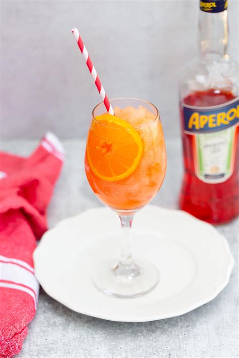 Frozen aperol spritz. Place ice cubes in a large wine glass. Pour in 3 parts prosecco. Pour in 2 parts Aperol. Pour in 1 part soda water. Garnish with a slice of orange and a pretty straw - and serve! 