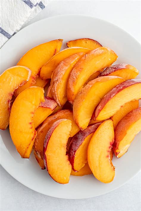 Frozen peaches. Arrange peach slices in a single layer on a baking sheet lined with parchment paper. Freeze until solid, around 2-3 hours. Transfer frozen peaches to freezer-safe bags or containers. Remove as much air as possible to prevent freezer burn. Store bags of frozen peaches in the freezer for up to a year. 