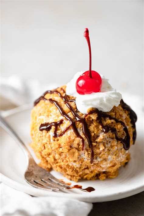 Frying ice. Place the coated ice cream balls into the air fryer basket and air fry for 1 minute at 400 degrees F / 204 degrees C. Remove from the air fryer and serve immediately. Garnish the fried ice cream with caramel and whipped cream, if desired. 