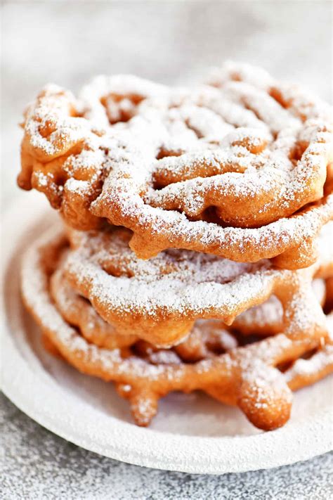 Funnel cake. In a large bowl, whisk together milk, eggs, water, and vanilla until well combined. In a medium bowl, stir together flour, sugar, baking powder, cinnamon, and salt until combined. Slowly whisk the flour mixture into the milk mixture until smooth. Using your finger, cover the bottom hole of a large funnel. 
