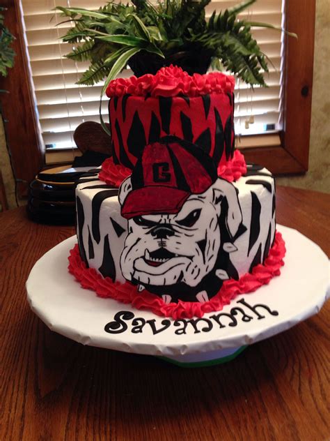 Ga bulldog cake. Georgia Bulldogs Cake. Sorry a couple of pics are sideways…. I had a lot of fun making this cake! It’s a red velvet with cream cheese frosting on top and a vanilla cake with orange buttercream on bottom. The bulldog is rice krispies and fondant, the football is … 