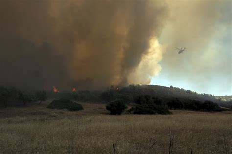 Gale-force winds are fanning dozens of wildfires across Greece, leaving at least 1 dead, 2 injured