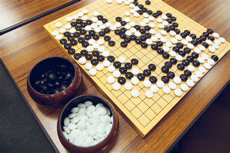 Game of go. Other needed materials for GO will be a board, and black-and-white stones to lay claim to territory. GO is traditionally played on a 19x19 line grid board, and can also be played on 5x5, 9x9, and 13x13 sized boards as well. Smaller boards are good for quicker games, learning, and skill development. 