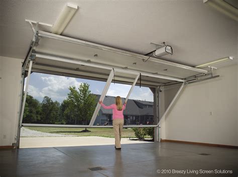 Garage door screen system. Retractable screens fit so well with garage doors because of their wide span coverage and ability to hook up to a power source in the garage. Depending on the design, they can also be customized to fit your garage. The motorized screen fits openings up to 22ft wide and 16ft tall. A retractable screen for a garage door can be used when the ... 