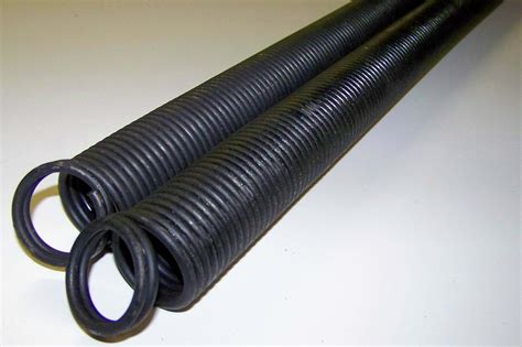 Garage door spring. The shaft one, get two short steel rods about 10 in in length. A stub of rebar will work. Insert one into one of the holes on the end "wheel." ... 