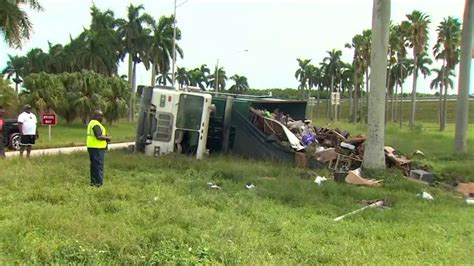 Garbage truck driver OK after rollover crash on Turnpike exit ramp in SW Miami-Dade