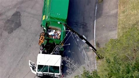 Garbage truck snags power lines in Newton