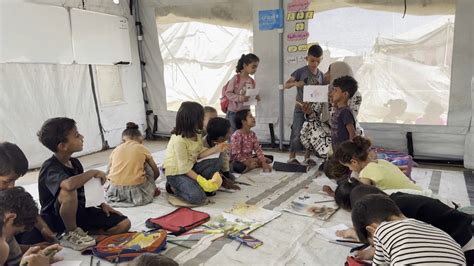 Gaza teacher forms learning space within a temporary structure during truce struggles