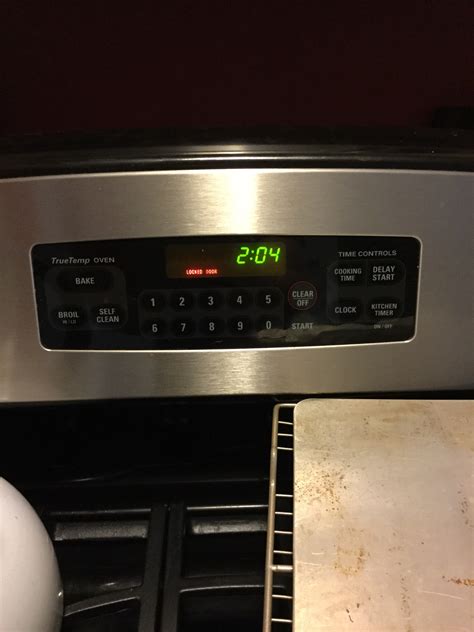 On my GE Profile wall oven, getting message - locked door On my GE Profile wall oven I was trying to set temperature and a little message appears "locked door". Door is open 1/2 inch.. 