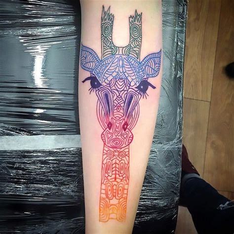 Geometric Tattoo An elegant, colorful tattoo of a giraffe head inked