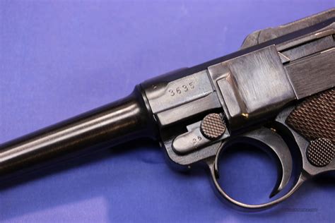 German luger serial number database. 1929 Swiss Luger SOLD! (109P) Serial #70255 in caliber 30 Luger (7.65mm Luger Auto), 4 1/2″ barrel, Black plastic checkered grips, nickel magazine, a rust blue finish. This is an excellent Swiss Luger with the famous Swiss Cross and shield on the rear of the toggle. The name of the importer is rolled on the front of the grip and says "SWISS 1929 7.65" with "PW ARMS REDMOND WA" below. 
