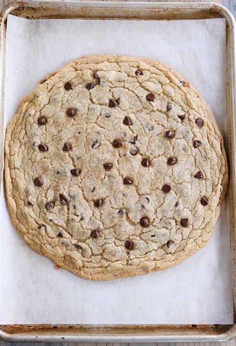 Giant cookie. Beat butter and sugars in the bowl of a mixer until well-blended. Add egg and vanilla and mix well. Add dry ingredients and mix just until incorporated. Add the chips, mixing by hand if needed. Using the back of a spoon or a wet hand, spread the dough evenly in the pan or skillet. Bake 20 minutes, or until golden. 