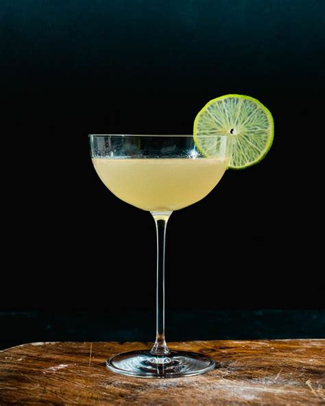 Gin gimlet cocktail. Cut the limes in half and reserve 1 slice as a garnish. Squeeze the lime juice into a jug. Fill a cocktail shaker with ice. Add all the ingredients and shake well. Strain carefully into a coupe glass, if necessary double straining through muslin to remove all the morsels of jam. Serve garnished with a slice of lime. 
