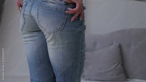 Girls taking their bikini bottoms off.  Use them in commercial designs under li...