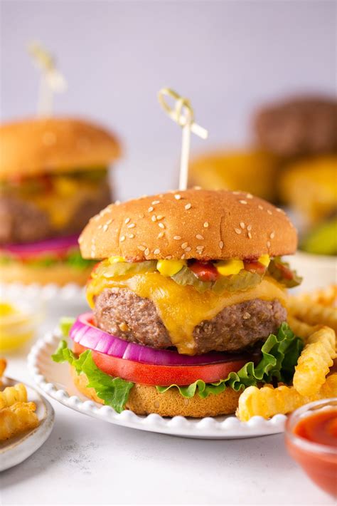 Gluten free burger. Place the beef in a mixing bowl, season lightly with salt and pepper and gently combine; do not overwork the meat. Divide the meat into four equal plump patties, taking care not to overly compress the meat. Make a slight dimple in the center of each patty with your thumb, which will encourage even cooking. Set aside. 