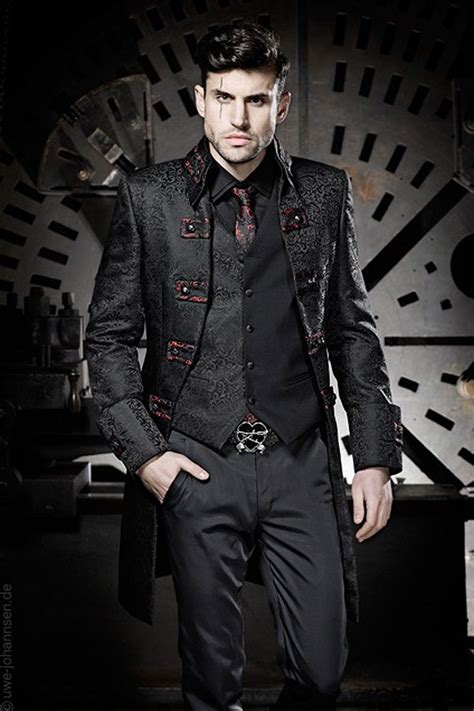 Gothic clothing for men. 15 – Plaid full-sleeve shirt with black vest and skinny jeans. This edgy ensemble blends punk-inspired elements with a gothic twist, creating a rebellious and stylish look. The outfit is a plaid full-sleeve shirt, exuding a grunge vibe, paired effortlessly with a sleek black vest adorned with various distinctive pins. 