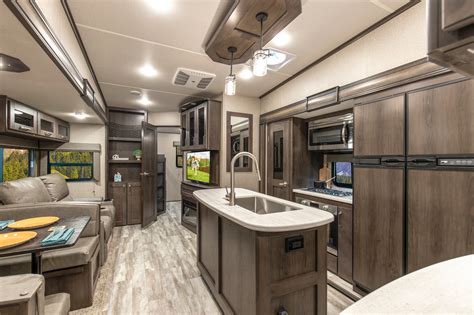 Solitude S-Class | 3740BH. This fifth wheel has got bunks on bunks on bunks - with two bedrooms for maximum comfort and privacy, each with their own bathroom. You can fit all of your kids, friends, or dogs in this beautiful bunkhouse with space to spare. With the added bonus of an outside bar - this has got all the features you need and then some.