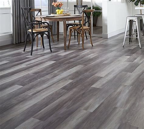 Gray vinyl flooring. Whitfield Gray Luxury Vinyl Planks, proudly made in the USA, present an exquisite fusion of gray tones with subtle knots and grains to achieve an authentic wood-look. This waterproof flooring is backed by a lifetime residential warranty for added peace of mind. 