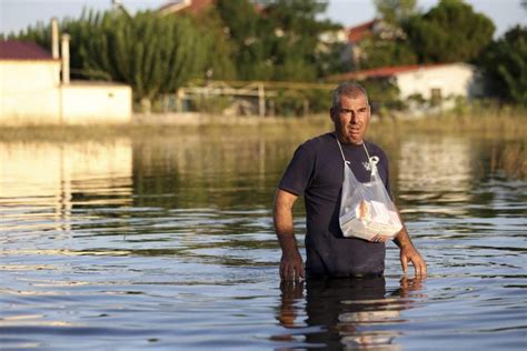 Greek authorities say a 77-year-old man is 11th victim of flooding. At least 6 people are missing