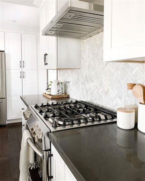 Grey and white herringbone backsplash. .  ...