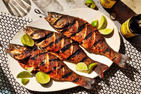 Grill fish. Place the fish in the BBQ fish basket. 4. Grill for 10 - 12 minutes (5-6 minutes each side), or until a skewer inserted in the thickest part goes all the way through. 5. While the fish is cooking, make the dip. Add the shallots, garlic and chillies to a pestle and mortar and grind and pound until you get a paste. 6. 