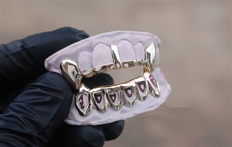 Solid Two Tone White Gold Diamond Cut with Diamond Dust Grillz [CUSTOM-FIT] 4.692307692 / 5.0 (26) 26 total reviews. from $285.00 Kim K Style Diamond Bar Bottom Grillz [CUSTOM-FIT] 4.636363636 / 5.0 (22) 22 total reviews. from $480.00 Solid Iced 6 Teeth Connecting Bridge Grillz Bar [CUSTOM-FIT]