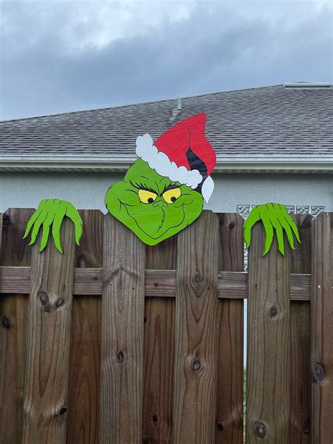 Grinch over the fence. Check out our grinch yard art fence selection for the very best in unique or custom, handmade pieces from our shops. 