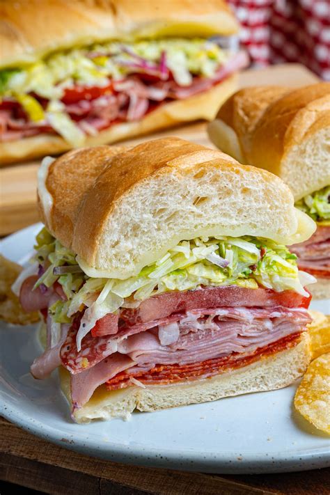 Grinder sub hoagie. Feb 5, 2024 · Sandwich Instructions. Preheat the oven to 425°F. Open the hoagie rolls and place them on a large baking sheet. Layer one side of each roll with salami, ham, turkey, prosciutto, and provolone cheese. Place in the oven and toast for 6-8 minutes, until the cheese has melted and the bread is lightly toasted. 
