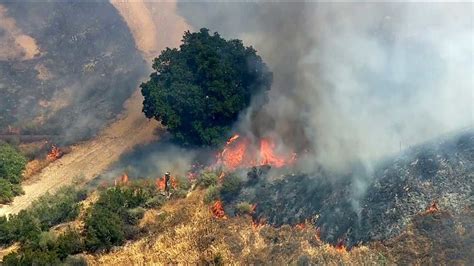 Growing brush fire breaks out in Newhall Pass