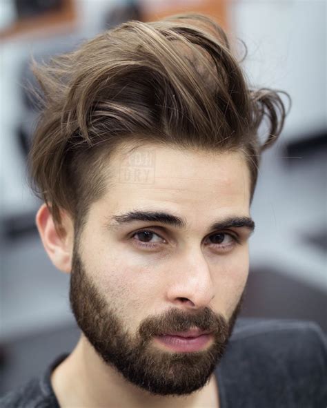 Growing hair out men. Don't cut until it's long. Once it's long have a few inches cut every 3-4 months to keep it strong and neat. Twist the ponytail or bun Upwards first then back down before tying, it's will keep the elastic from pulling back on your hair so much (so much more comfortable). Trim the sides yourself when "wings" or stray hair start leaving the fold ... 