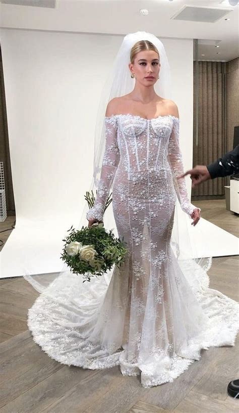 Hailey bieber wedding dress. See photos of Hailey Bieber's strapless lace dress with "Till death do us part" embroidered on the train. The bride and groom wore … 