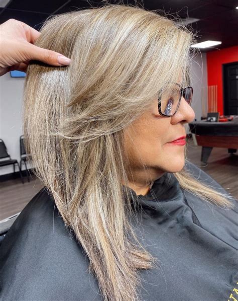 "This hairstyle showcases new gray hair growth beautifully and the length adds volume throughout," says Lliguin. The stylist recommends using a sea salt spray to enhance your natural texture along with a leave-in treatment to smooth over split ends. Tristar Media/Contributor/Getty Images. 4. Long Layers. 