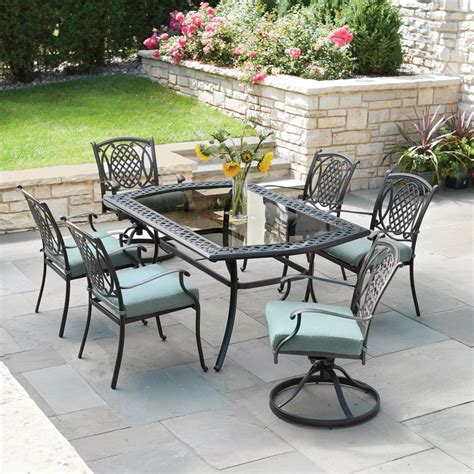 Upgrade your patio furniture with this Hampton Bay Geneva 7-Piece Brown Wicker Outdoor Patio Dining Set. The rust-resistant steel frames and wicker backs enhance the design of your outdoor space. This set includes two swivel chairs, four stationary arm chairs and a slat tabletop. This set is easy to clean with mild soap and water.. 