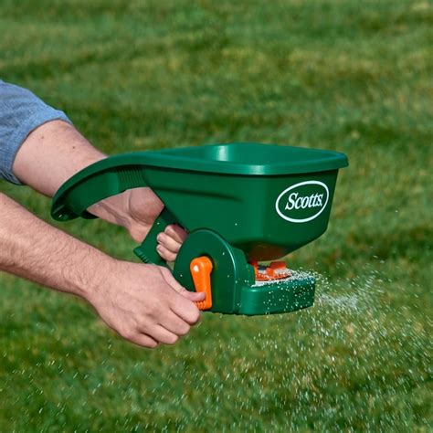 Scotts Wizz Spreader - Handheld Power Spreader, Use Year-Round, Covers Up to 2,500 sq. ft., Brown Chapin 8740A: 64-Ounce Black Poly Hand Shaker Spreader for Turf, Fertilizer, Grass Seed, Salt and Sand, Year-Round Use, Large Grip Handle with 3 Openings for Pellets and Particles