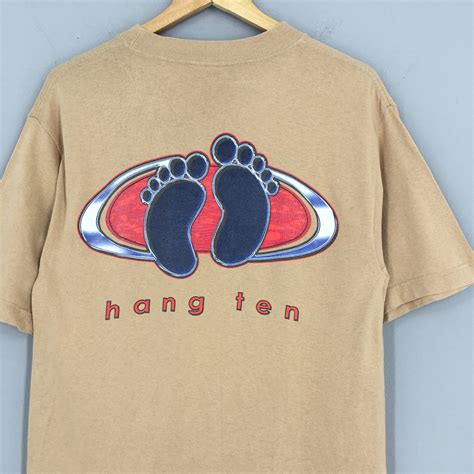 Hang ten clothing. Product Description: Soft feeling on the skin, this quality t-shirt from Hang Ten is a true wardrobe essential. Crafted in high quality Jersey fabric, Regular Fit T-Shirt with Lace details at shoulder and sleeves. This practical and versatile tee pairs... 