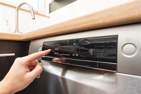 The reset button on a GE dishwasher is typically located on