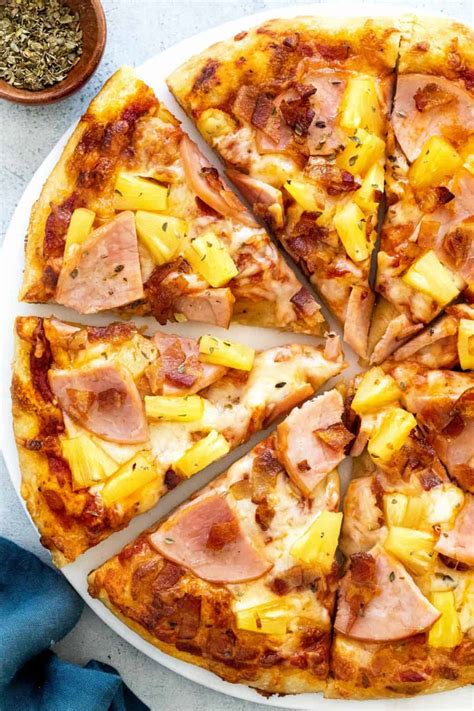 Hawaiian pizza toppings. Jan 19, 2021 · Preheat oven to 500°F/260°C. Divide the dough into 3 equal balls. On a piece of parchment paper, stretch the dough ball into a disc about 10" in diameter. Spread a few tablespoon of tomato sauce on the dough, add sliced ham, pineapple, and sprinkle with cheese. 