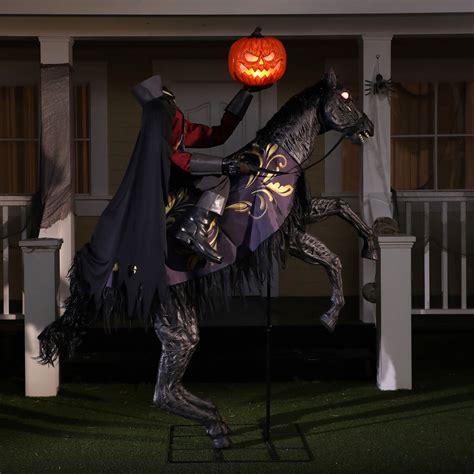 Design & Details. Inspired by the classic Headless Horseman tales, this terrifying decoration captures the ture essence of the villain in a creepy animatronic. The piece is draped in dark red clothing and wears a jagged black cape. He holds a smaller axe in one hand, with an eerie Jack-o-Lantern in the other hand. . 