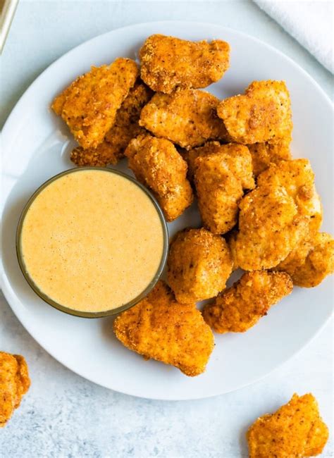 Healthiest chicken nuggets. A five-nugget serving of NUGGS packs 13 grams of protein and 10 grams of fat. That's the same amount of protein and six fewer grams of fat than you'd find in an equal portion of Tyson chicken nuggets. Plus, a serving of these vegetarian chicken nuggets contains 45 fewer calories than the real-meat version. 