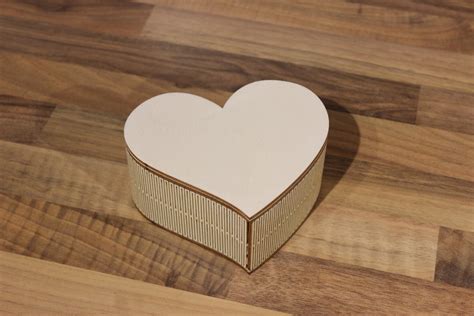Heart box. It dries fast and holds strong. Start by gluing the long side flap. Then glue the flap on the underside of the top part to create a dart in the front and back of the heart. Glue the top side flaps next. Now you can fill your 3D paper heart boxes with any goodies you want. 
