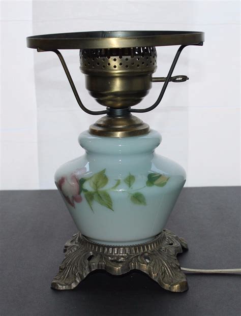 Up for bid is a Vintage HEDCO Inc Hurricane Table Lamp Gone With The Wind Inlay Floral Pattern 20" High. Small bulb is included. Regular bulb is not included. The lamp is in a good working condition. The shade has couple small spots with missing paint. One foot of the metal base has small crack almost invisible. Please see the pictures and ask any questions before bidding.