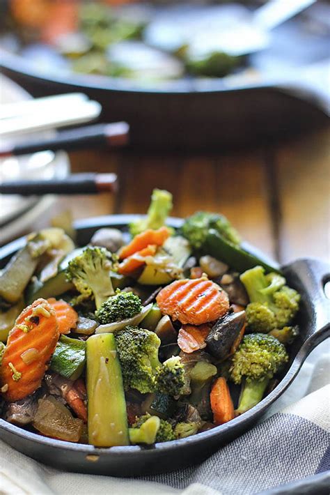 Hibachi veggies. In a large heavy duty skillet, melt 1 1/2 tablespoons of butter over medium heat. Add the onion and saute until starting to soften, about three minutes. Stir in the frozen vegetables and cook until heated through, another few minutes. Stir in the garlic and saute until fragrant, about 30 seconds. 