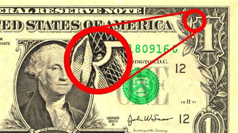 The thread is imprinted with the text USA TWENTY and a small flag in an alternating pattern and is visible from both sides of the note. The thread glows green when illuminated by …. 