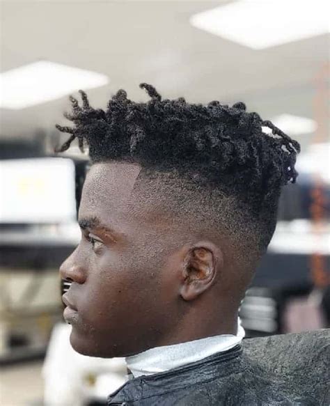 Kinky hair taper fade is a popular choice for black men of all ages. The gradual reduction of hair length in this fade haircut merges with the facial lineup to give the model a clean, well-shaved look. No maintenance is required, just keep your natural hair kink-free.. 