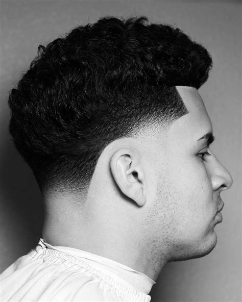 Hispanic low fade curly hair. Keep the temple points shaped at a very straight, 90 degrees angle and the top part longer with small, coiled curls with an equal proportion between a messy shape and a bit of definition. 8. Taper Fade with Curly Top Hairstyle For Men. Source. 