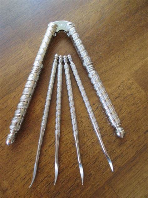 This is one of the classic HMQ nutcracker sets consisting of a spring-jointed nickel-plated solid steel nutcracker and six nut picks. The HMQ stands for Henry Marcus Quackenbush (1847-1933), a rather prolific inventor, who patented his nutcracker in 1913. (He had invented the extension ladder in 1867 and an air pistol in 1871, the year he ...